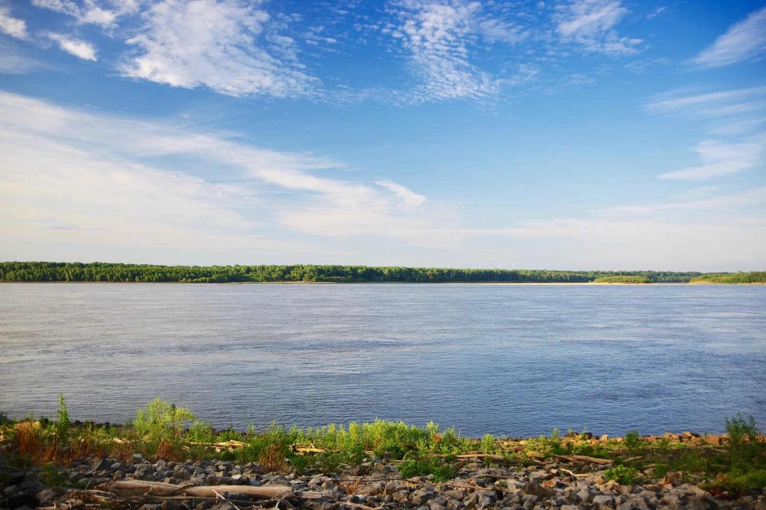 The wide Mississippi River at Caruthersville under a blue sky